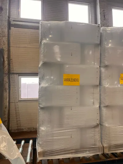 Pallets of 250 L bags of white peat in the warehouse